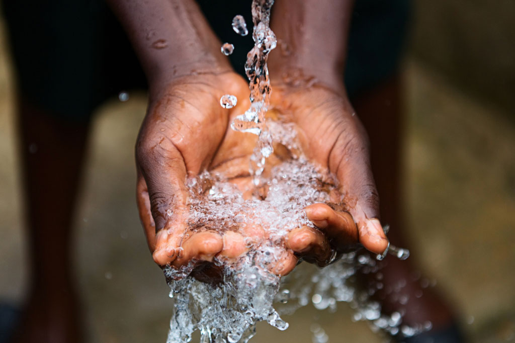 water flowing into cupped hands